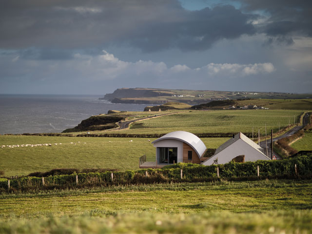  Grand Designs renovations. Blacksmith forge conversion curved steel roof triangular roof next to coastline