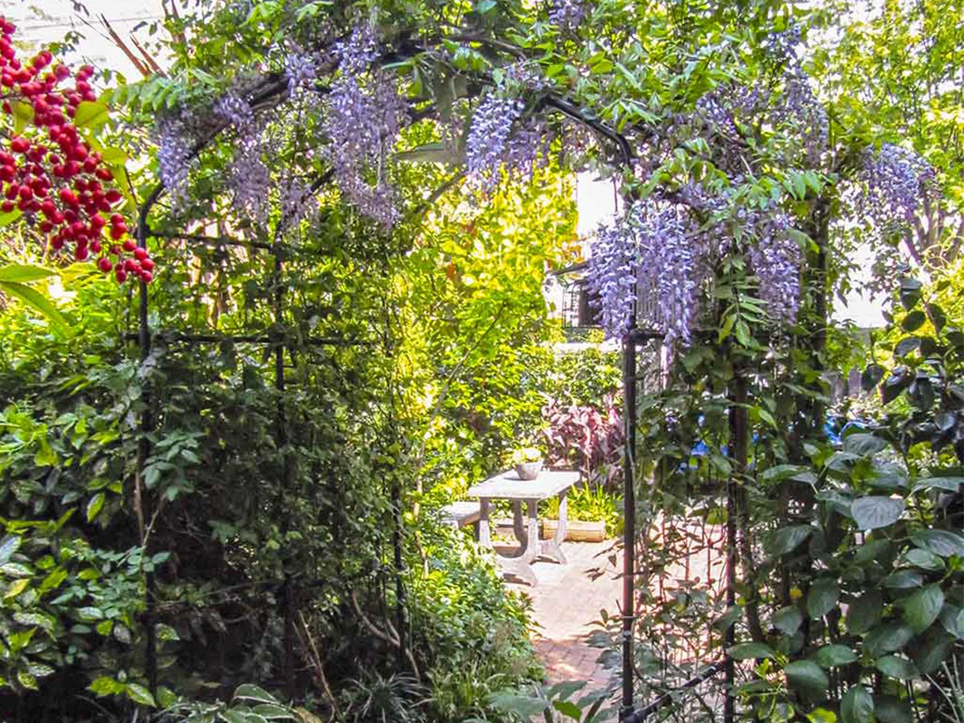 Add height to a small garden with an arch to bring visual interest