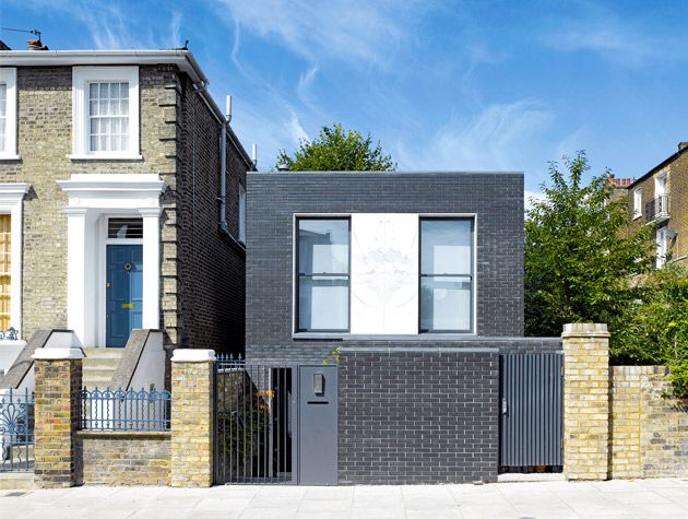 Black brick home exterior end of Victorian terrace 