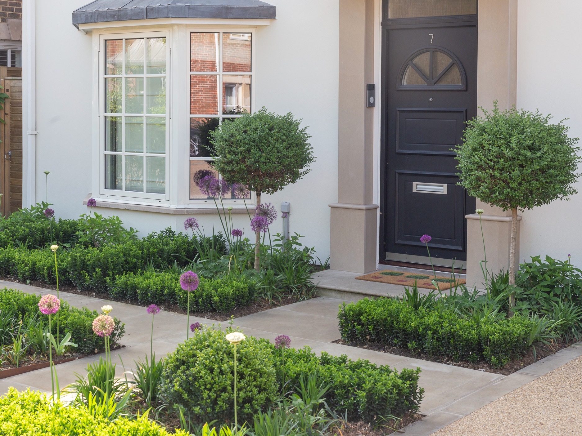 Front garden with pathways and low borders with shrubs