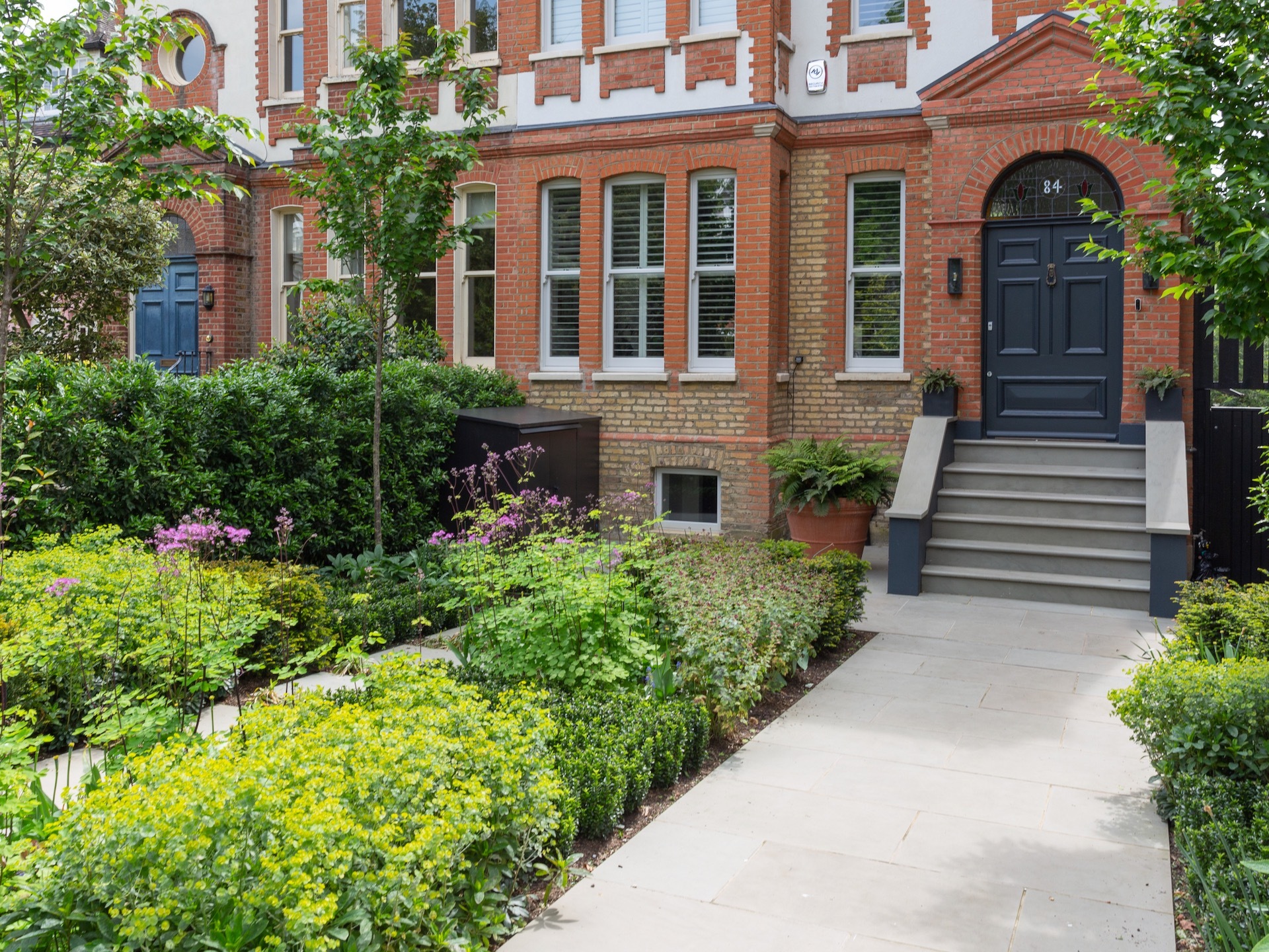 Front garden by Belderbos landscapes with wild flower planting and wide path