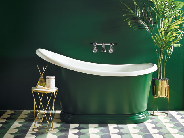 vintage bathroom. Green slipper bath green painted wall off floor potted plant gold side table 