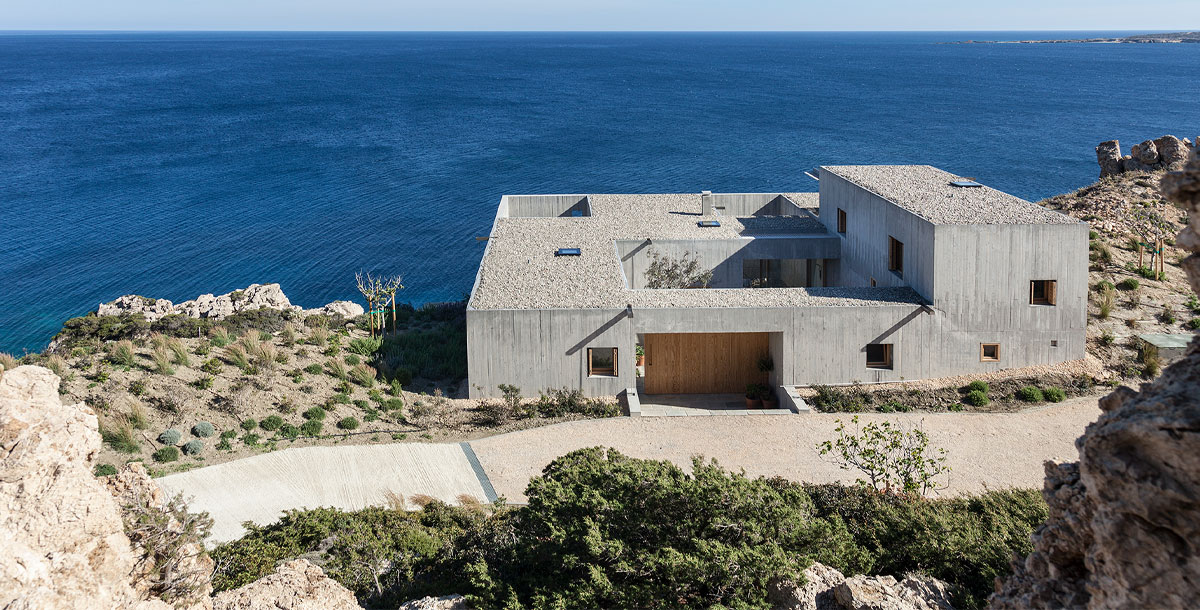 Concrete coastal home in Greece by OOAK Architects