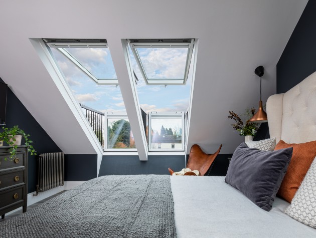 converted loft with bed and a leather chair