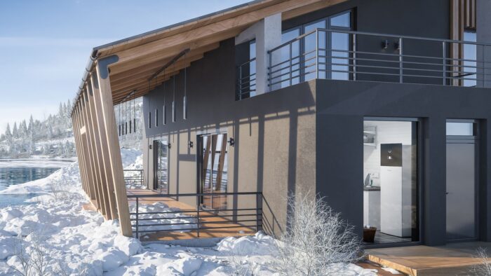 A ground-source heat pump visible through the window in a striking modern build