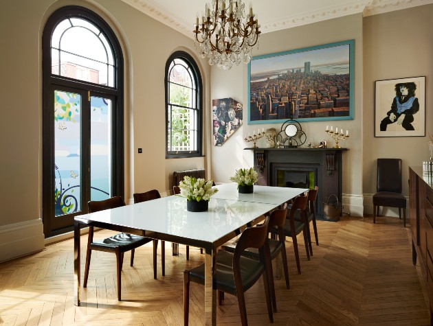 dining room with table chairs fireplace chandelier and wooden floor