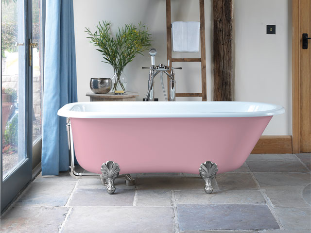 pink rolltop bath with silver traditional feet stone floor