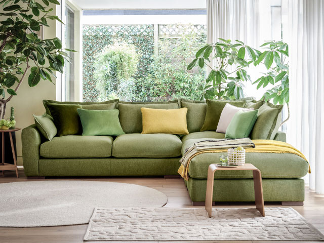 sustainable green corner sofa with yellow and green scatterback cusions and right-hand chaise