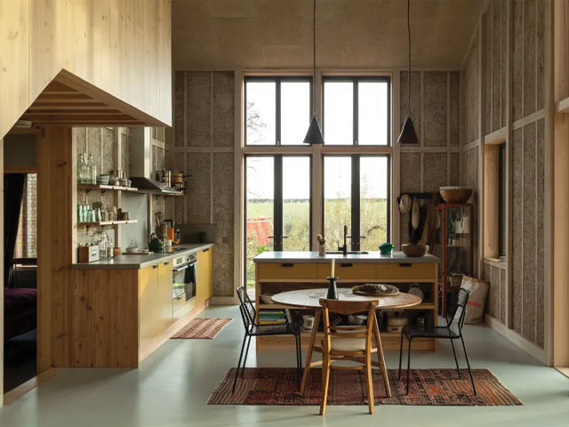 Inside the Flat House hemp barn conversion with exposed wood and hempcrete walls