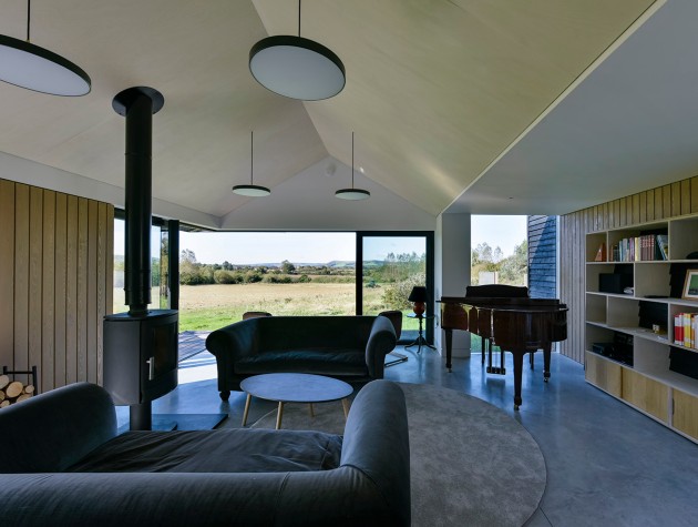 interior of modern house with wood burner sofas and piano