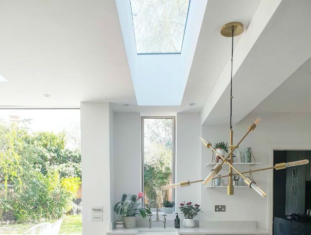 kitchen with , roof light, island light fitting and view of garden