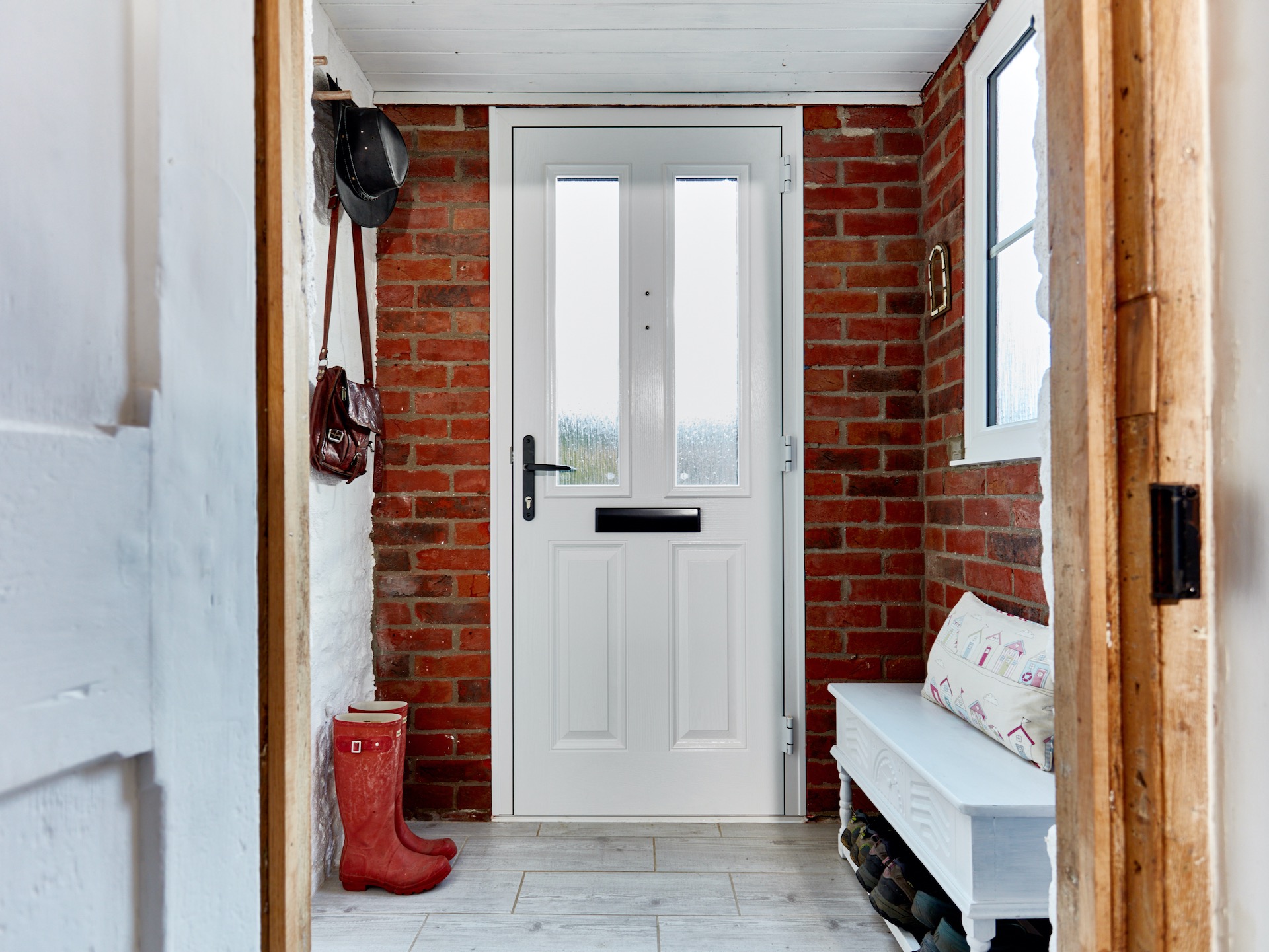 View into porch with bench and boots