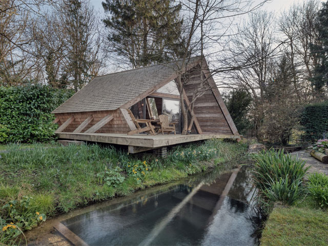 The Climbers Cabin. outside deck with stream and woodland behind 