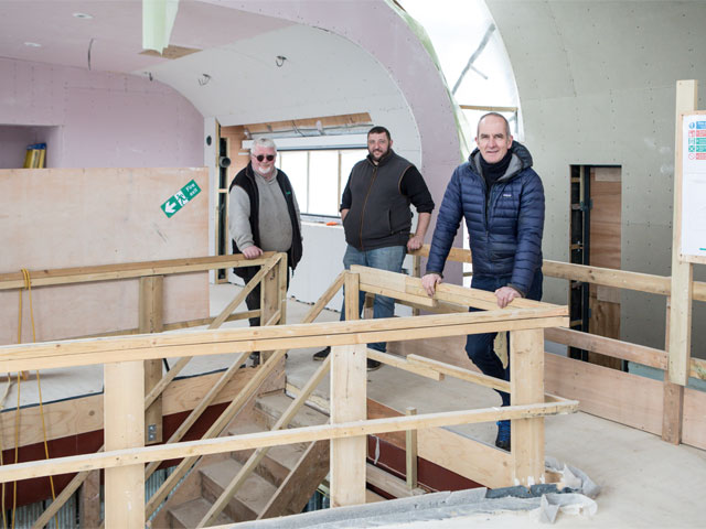 Kevin McCloud Tim and Michael unfinished interior wood staircase curved wall curved glass