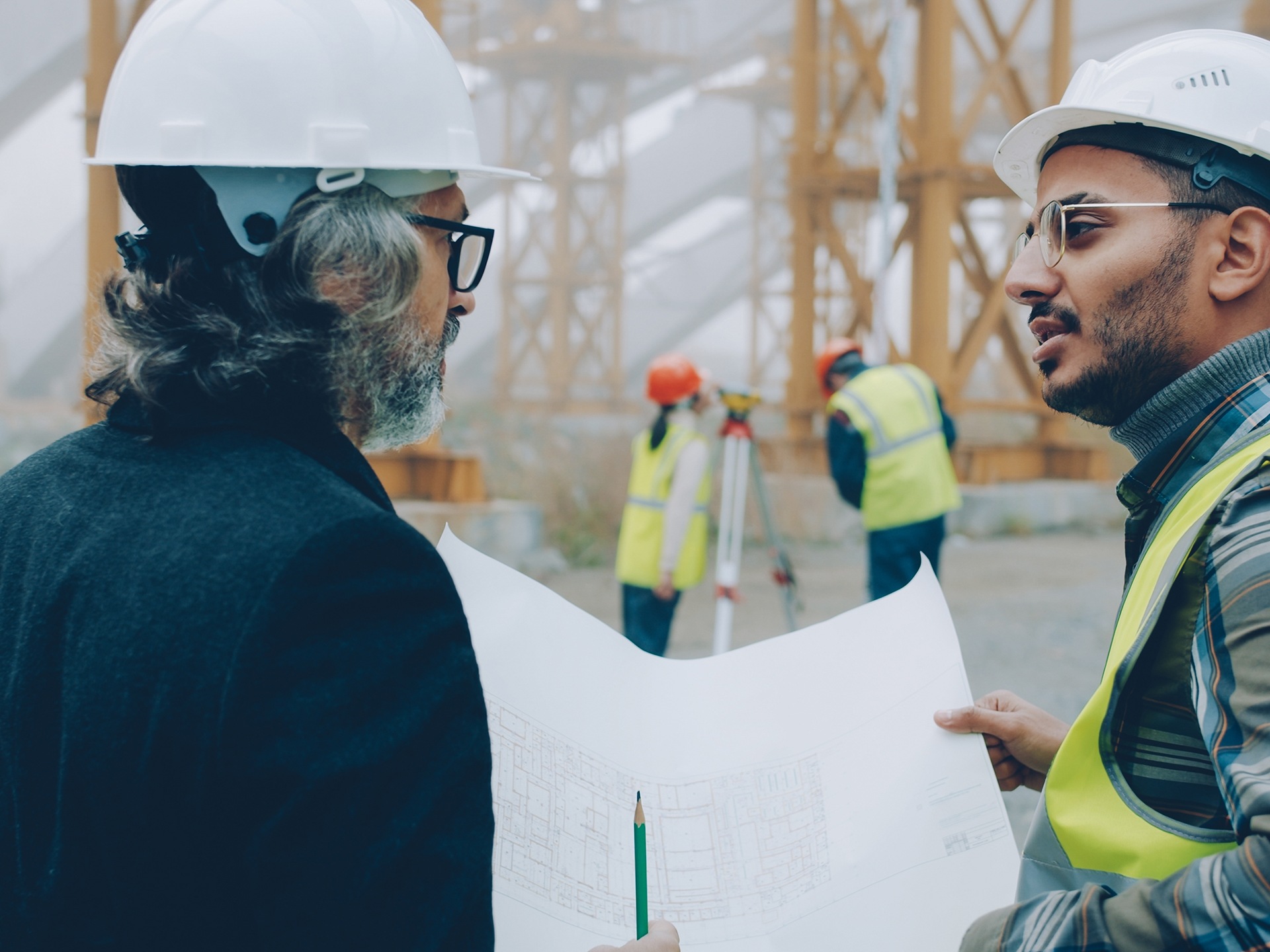 Two surveyors on a building site