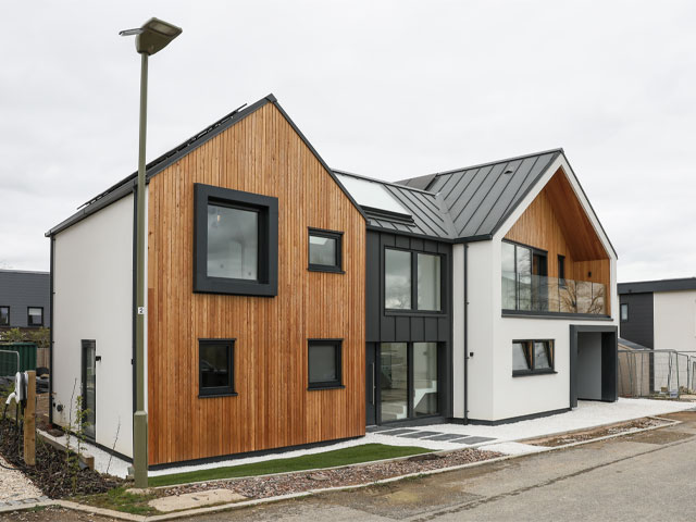 Grand Designs The Streets modern minimalist home exterior zinc roof white rendering aluminium windows